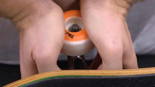How to Put Wheels on a Skateboard - Put the wheel onto the bearing 
