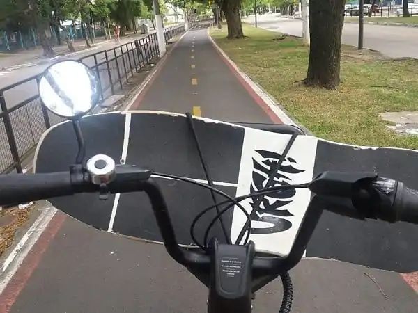 How to Carry a Skateboard on a Bike - Lay the board upside down on handlebars